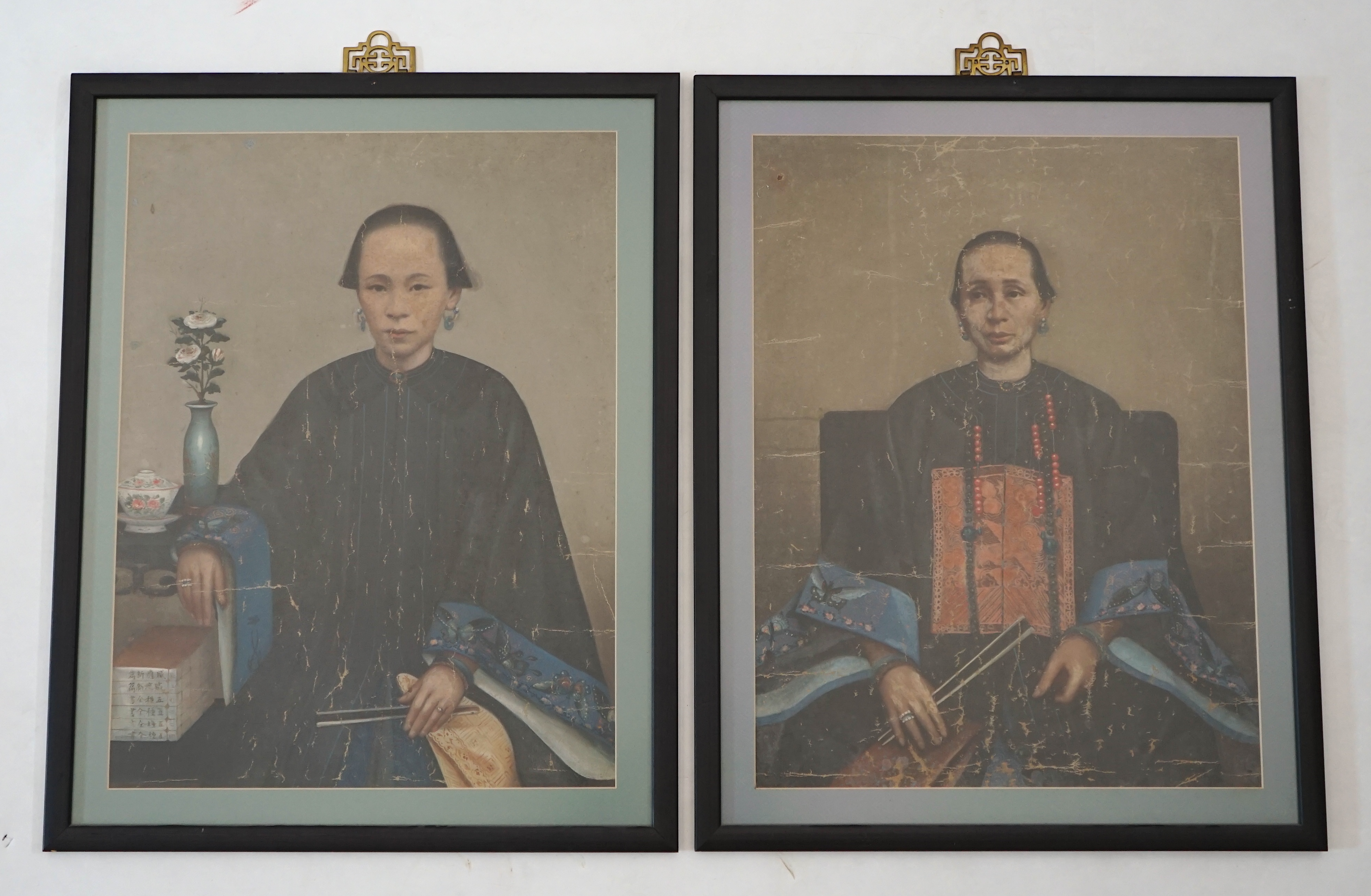 China Trade, late Qing dynasty, two portraits of Qing ladies, oil on canvas, each 63 x 47cm, later framed and glazed. Condition - poor to fair